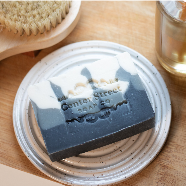 Perfect Man Handmade Soap Bar by Center Street Soap Co. on a handmade ceramic round soap dish